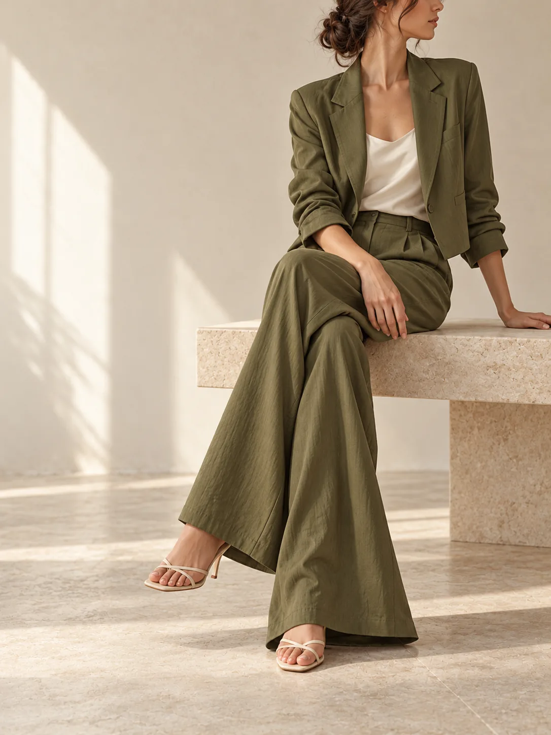 Olive tailored co-ord set in an editorial interior