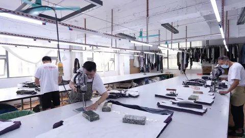 OTO cutting team uses electric cutters to prepare fabric panels