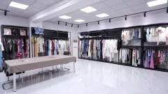 OTO showroom with sample garments and a presentation table