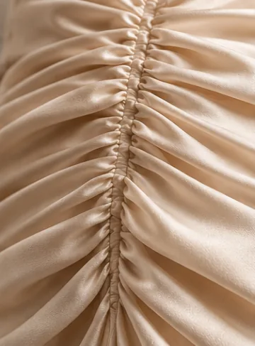 Ivory satin gathered into a central shirred seam